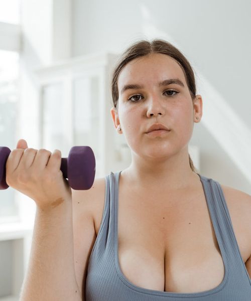 Focused individual holding a weight, showing concentration and strength.